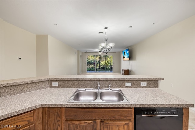 kitchen featuring dishwashing machine, sink, and a chandelier