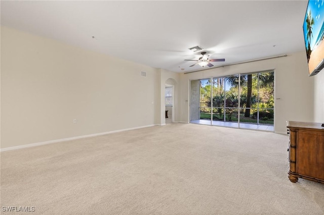 unfurnished living room with ceiling fan and light carpet