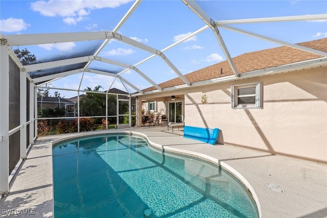 view of swimming pool with a patio area and a lanai