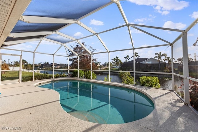 view of pool featuring a patio area, a lanai, and a water view