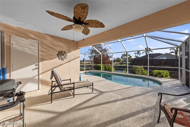 view of swimming pool with a lanai, grilling area, and a patio