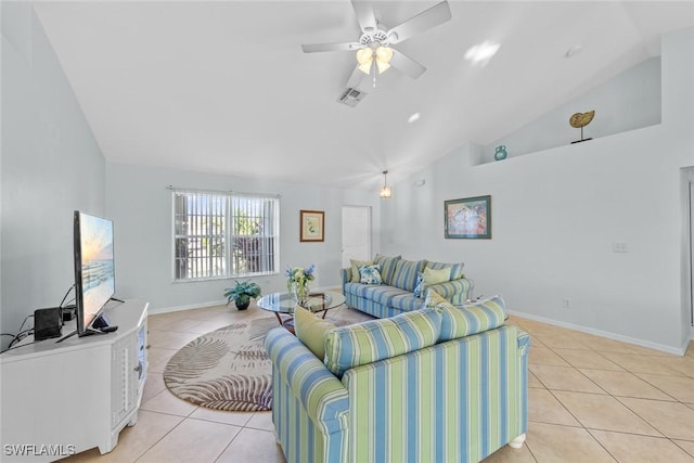 living room with ceiling fan, lofted ceiling, and light tile patterned flooring