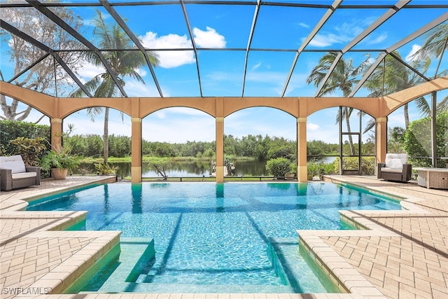 view of pool with a patio area, a water view, and a lanai