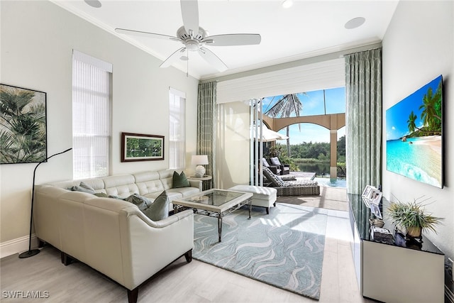 living room featuring light wood-type flooring, ceiling fan, and crown molding