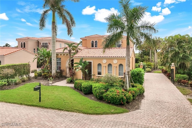 mediterranean / spanish-style house with a front yard