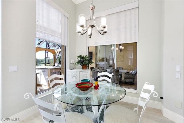 dining room featuring light hardwood / wood-style flooring and a notable chandelier