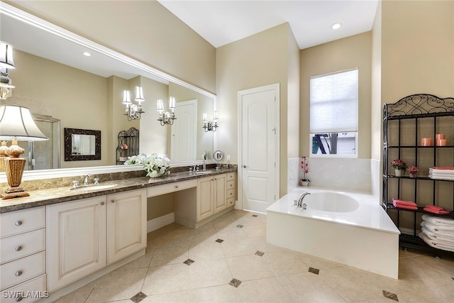 bathroom featuring tile patterned flooring, a bathtub, and vanity