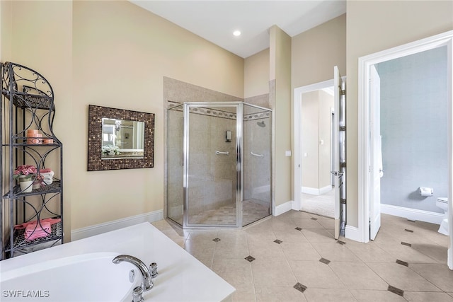 bathroom featuring toilet, shower with separate bathtub, and tile patterned flooring