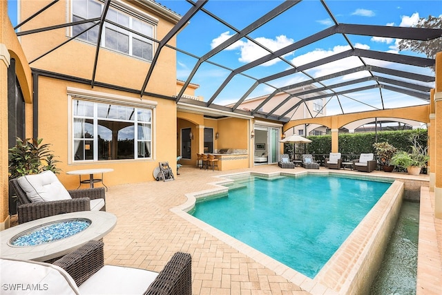 view of swimming pool featuring a hot tub, glass enclosure, a patio area, and an outdoor living space