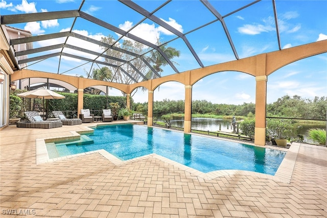 view of pool featuring a lanai, a water view, and a patio area