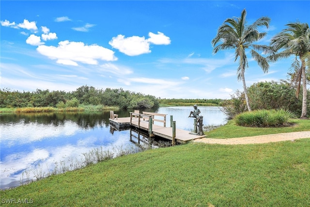 view of dock with a water view and a yard