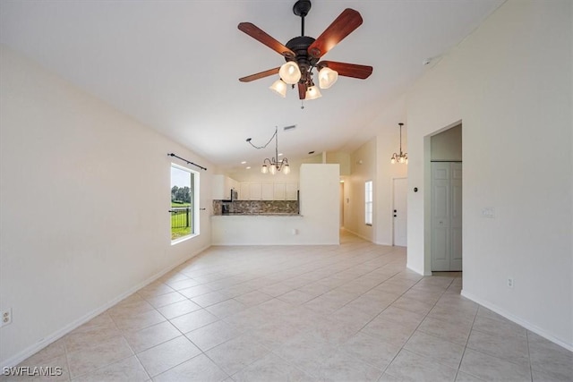 unfurnished living room featuring ceiling fan with notable chandelier and light tile patterned flooring