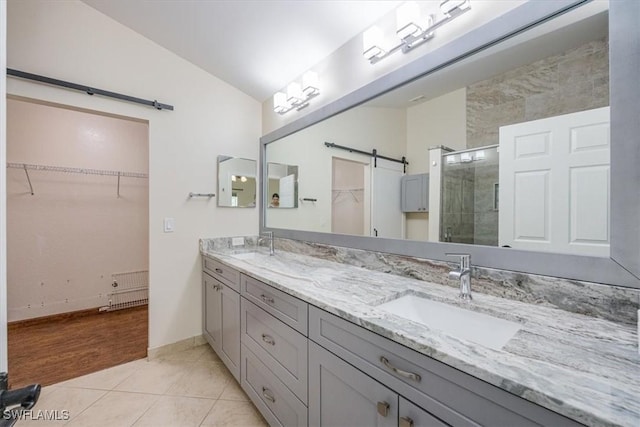 bathroom with tile patterned flooring, vaulted ceiling, vanity, radiator heating unit, and a shower with shower door