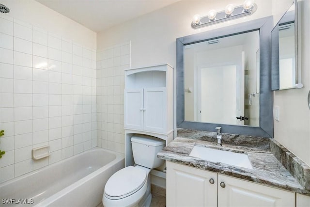 full bathroom featuring toilet, tiled shower / bath, and vanity