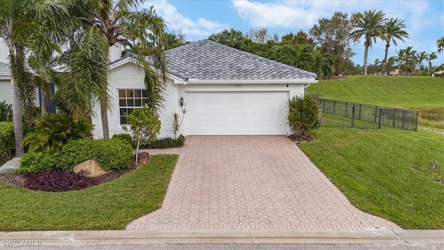 view of front of property with a garage and a front lawn