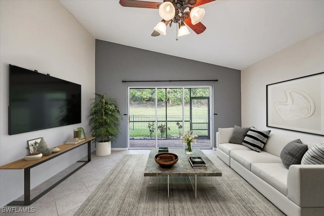 living room with lofted ceiling, ceiling fan, and light tile patterned flooring