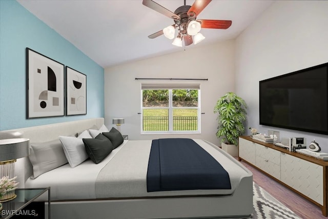 bedroom with hardwood / wood-style floors, ceiling fan, and vaulted ceiling