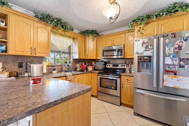 kitchen with ornamental molding, appliances with stainless steel finishes, a textured ceiling, light tile patterned floors, and light brown cabinets