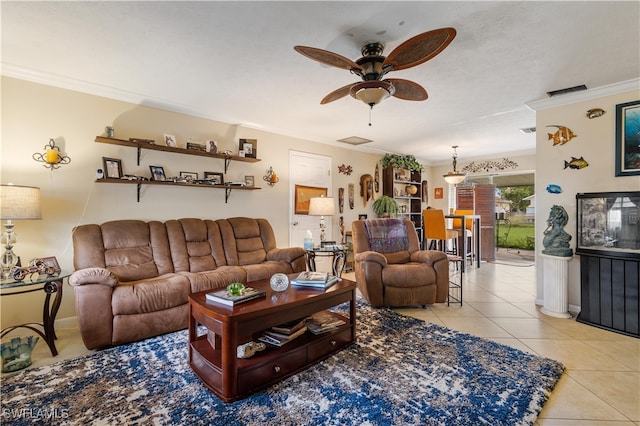 living room with ceiling fan, light tile patterned floors, and ornamental molding