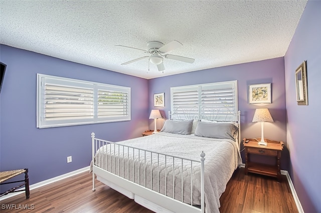 bedroom with a textured ceiling, wood-type flooring, and ceiling fan