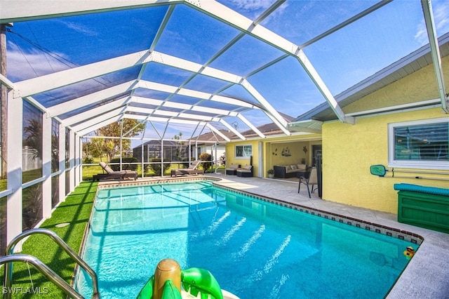 view of pool with a patio and a lanai