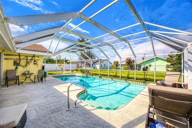 view of pool featuring a yard, a patio area, and a lanai