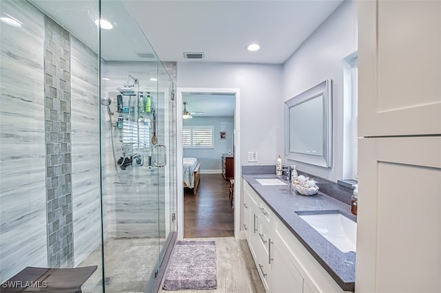 bathroom featuring vanity, ceiling fan, wood-type flooring, and walk in shower