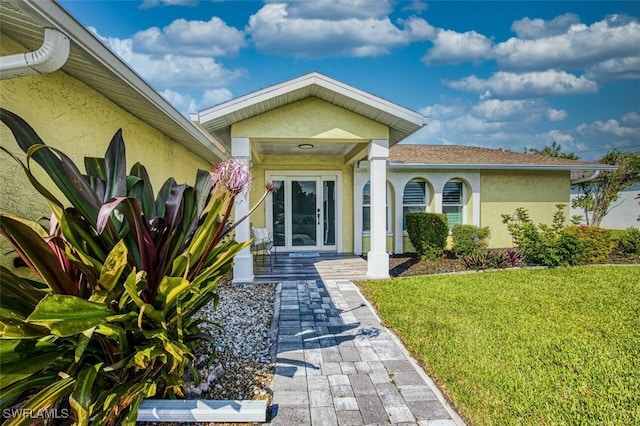 doorway to property featuring a yard