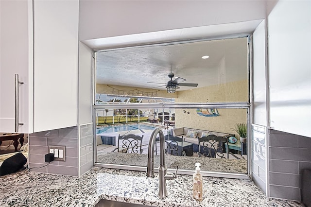 interior space with sink and ceiling fan