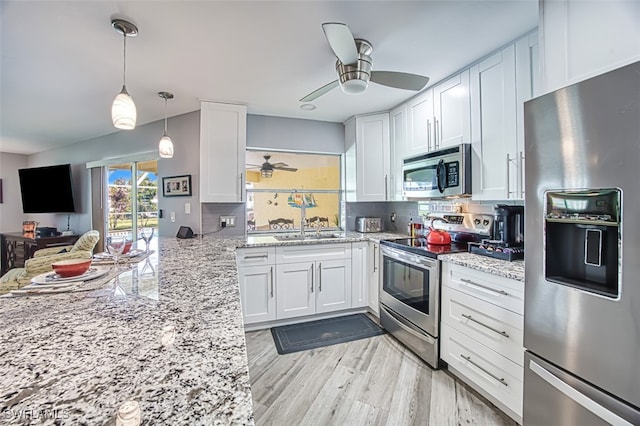 kitchen with sink, white cabinetry, light hardwood / wood-style flooring, and stainless steel appliances