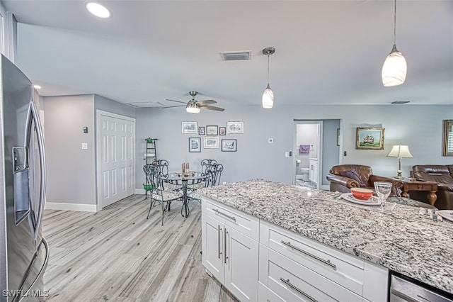 kitchen featuring light hardwood / wood-style flooring, stainless steel refrigerator with ice dispenser, white cabinets, and decorative light fixtures