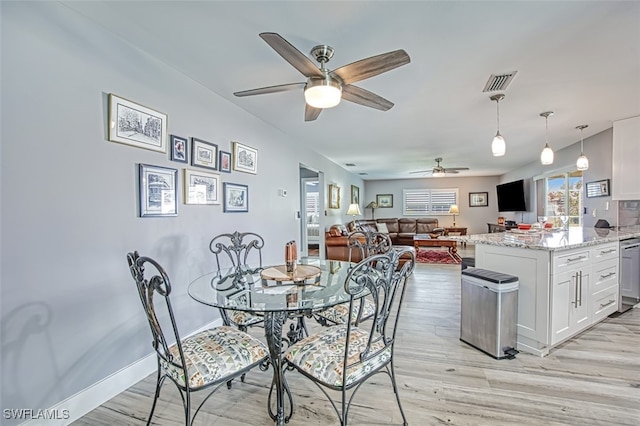 dining room with light hardwood / wood-style flooring and ceiling fan