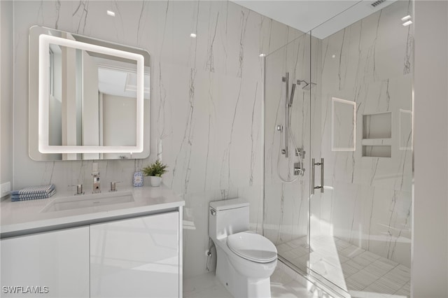 bathroom with vanity, toilet, and a shower with shower door