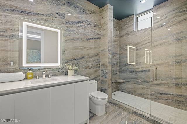 bathroom featuring vanity, toilet, tile walls, and walk in shower