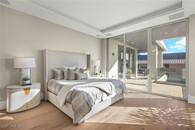 bedroom featuring access to exterior and light hardwood / wood-style flooring