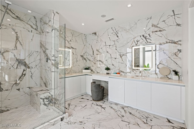 bathroom with vanity and a shower with shower door