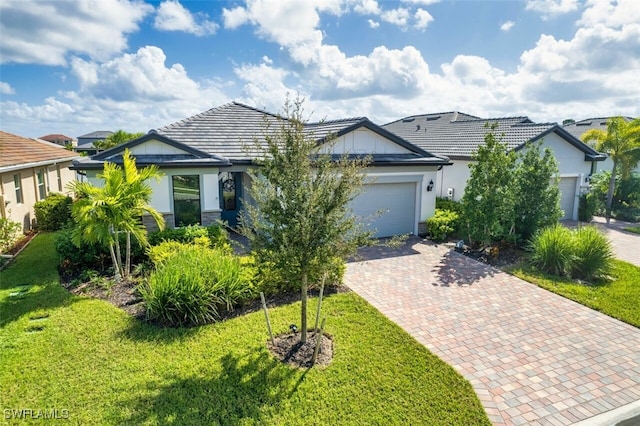 view of front of property with a garage and a front lawn