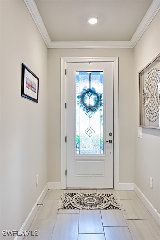 foyer entrance featuring ornamental molding and light tile patterned flooring