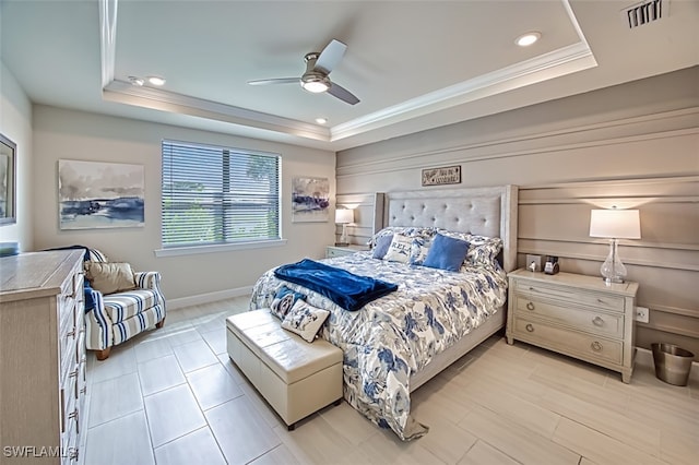 bedroom featuring crown molding, a tray ceiling, and ceiling fan