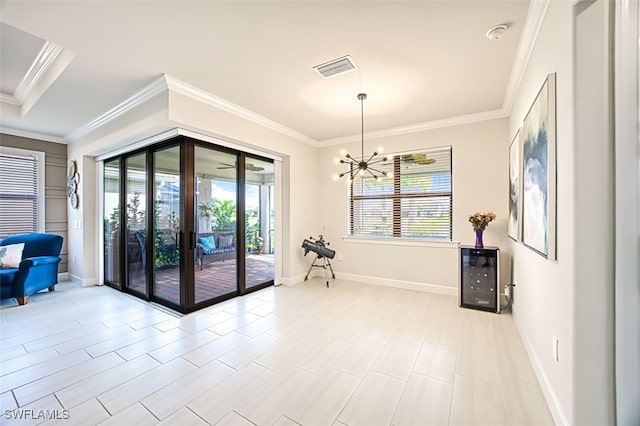 interior space with crown molding and a chandelier