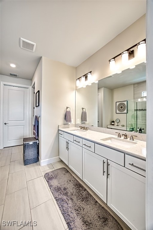 bathroom featuring vanity, walk in shower, and tile patterned floors