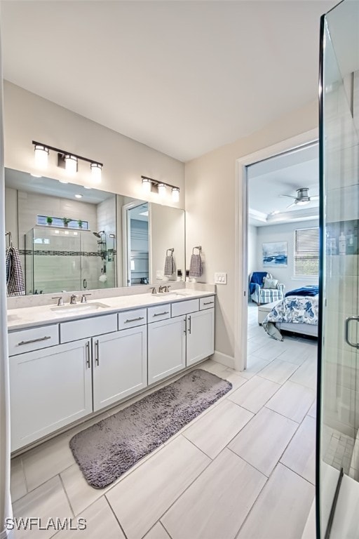 bathroom with vanity, walk in shower, tile patterned flooring, and ceiling fan