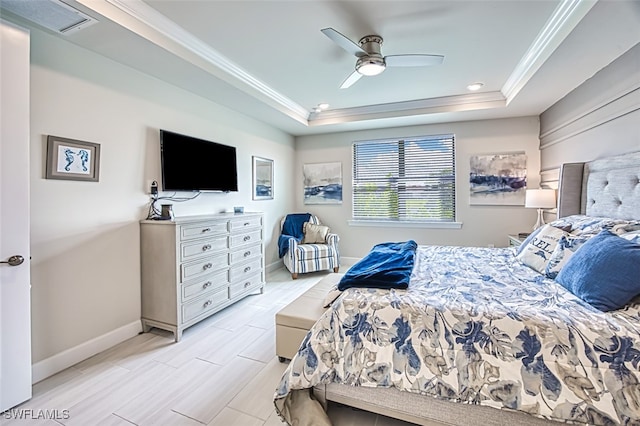 bedroom with ornamental molding, a tray ceiling, and ceiling fan