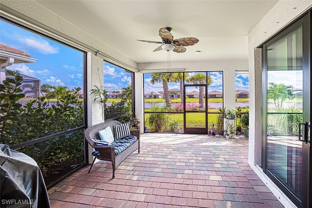 sunroom featuring ceiling fan