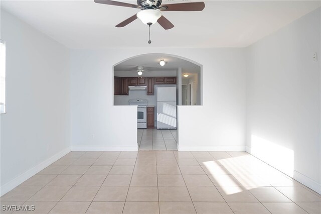 spare room featuring light tile patterned floors and ceiling fan