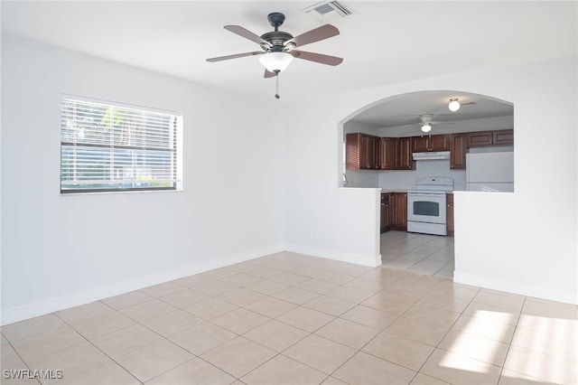 12602 Fourth St, Fort Myers, FL 33905 - unfurnished room featuring ceiling fan, arched walkways, light tile patterned floors, and baseboards