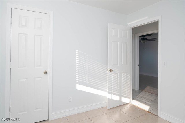 hall with light tile patterned floors