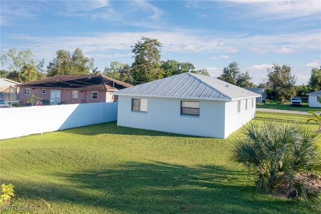 rear view of property with a lawn