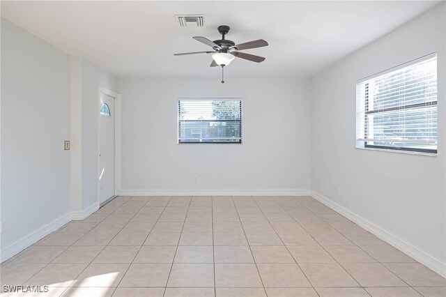 unfurnished room featuring ceiling fan and light tile patterned flooring