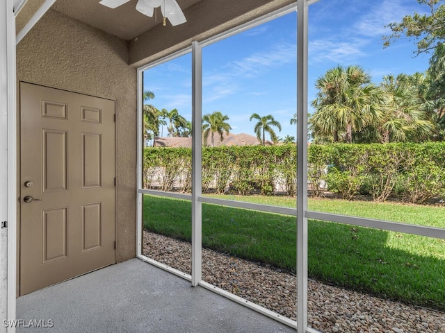 unfurnished sunroom featuring ceiling fan and lofted ceiling